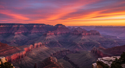 Naklejka premium Dramatic canyon landscape deeply illuminated by a stunning fiery sunset painting the ancient rock formations vibrantly. AI Generated