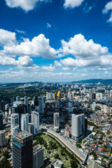 Naklejka premium Stunning aerial view of Kuala Lumpur city skyline under a blue cloudy sky