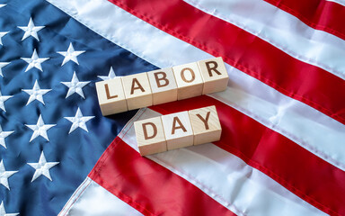 LABOR DAY word made by wooden blocks over United States of America flag