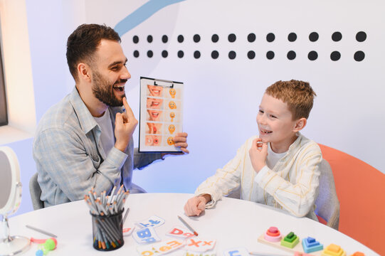 Speech therapist working with child on articulation practice