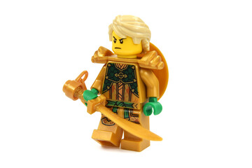 Obraz premium Editorial illustrative image of lego minifigure of golden ninja Lloyd with blade or sword weapon isolated on white. Jubilee of lego Ninjago.