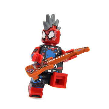 Lego minifigures of Spiderman is playing a guitar. Editorial illustrative image of popular children toys and movie Marvel.