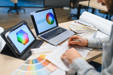 Interior designer working on architectural plans and color palette