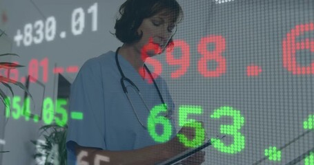 Stock market data animation over healthcare professional writing on clipboard - Powered by Adobe