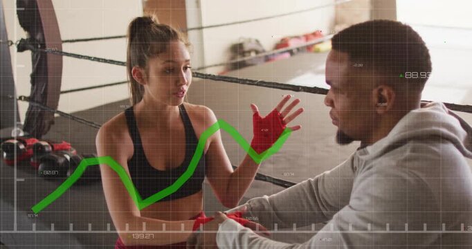 Boxing coach kneeling rewrapping hand wraps while rising performance graph guiding boxer gesturing