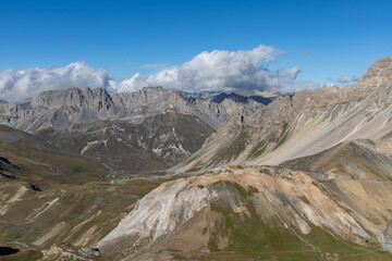 High-altitude mountain panorama from Col du Galibier in the French Alps, with sweeping views of peaks and valleys.