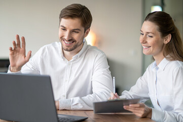 Obraz premium Colleagues having a video conference with the client and looking involved