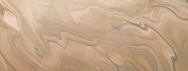 Abstract fluid art background in beige brown tones with marble texture and acrylic pour painting style, macro