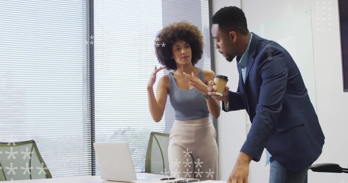 Animation of asterisks forming arrows over multiracial coworkers discussing over laptop in office