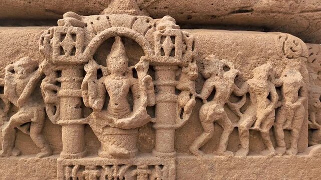Vadnagar, Gujarat, India ancient Kirti Toran stone sculpture relief showing carved human figures, historic architecture, Indian heritage, temple era craftsmanship, and archaeological monument details.