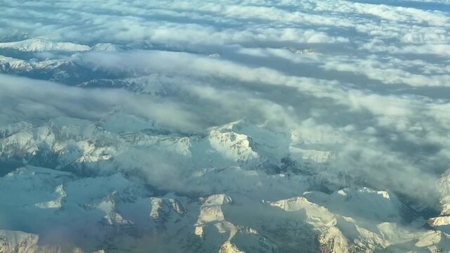 Elevated Aerial View of Snow-covered Aps Mountains Partially Covered By Cirrus Clouds