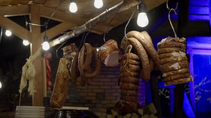 Traditional Smoked Meats Hanging on Hook on Rustic Farm Table