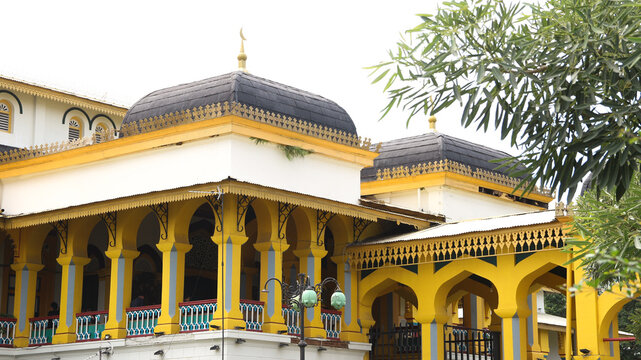 Medan, Indonesia - October 6, 2025: The magnificent architecture of Maimun Palace in Medan, Indonesia, showcases its iconic yellow color and unique blend of Malay, Islamic, and European design element