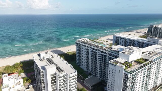 Drone Shot of Miami Beach, Florida USA, Oceanfront Buildings With Rooftop Pool, Condo Towers and Sandy Shore