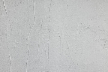 White concrete wall with fine cracks and matte surface texture, softly lit and balanced. Clean modern background featuring subtle negative space and ample copy space for text and graphics.