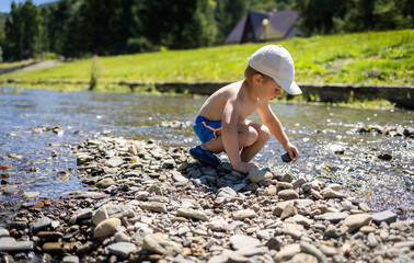 Cool mountain stream is a place for children to have fun during the hot summer