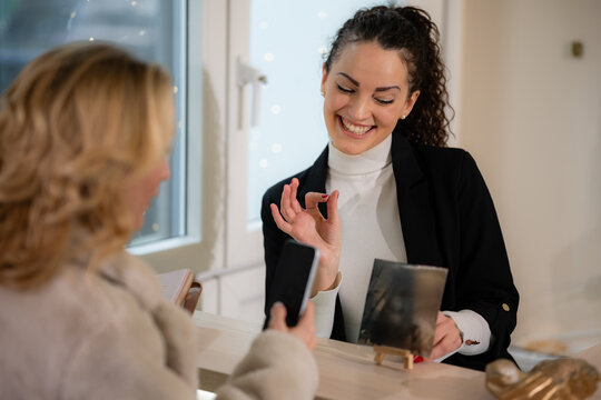 Woman paying for service using qr code with smartphone - Powered by Adobe