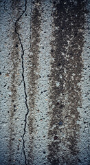 Fototapeta premium Vertical view of concrete with crack, showing textured surface and dark stains, representing deterioration, age, or structural issue