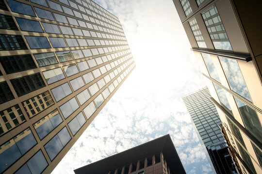 Frankfurt Germany skyscraper architecture corporate facade perspective sunlight on modern glass towers giving bright corporate skyline from low angle