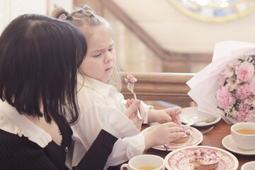 Mom daughter and grandma have a family holiday dinner in a cafe