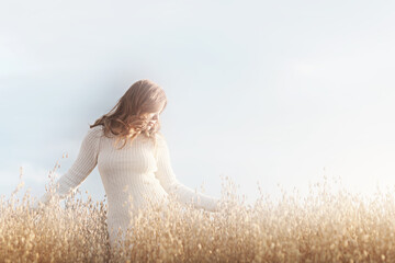 Summer Look female model posing in a field against the sky, the concept of natural freedom and femininity