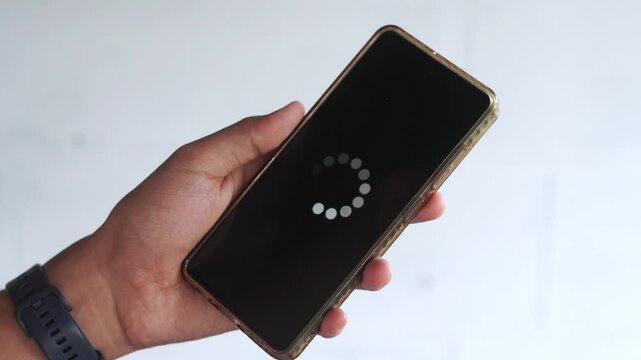 System error, slow loading, no connection to wifi on mobile smartphone screen in man hand. No signal internet connection on cellphone. System software update and upgrade loading process.