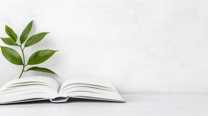 An open book with a plant on the left side.
