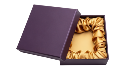 A luxurious gold satin scrunchie nestled in a rich purple gift box on a black background