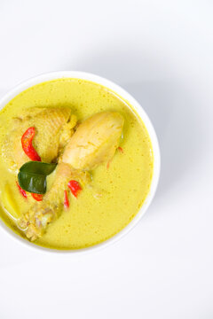 Opor ayam or Indonesian chicken stew in coconut milk is a festive delight, commonly served during Eid-al Fitr or lebaran. Isolated on white background