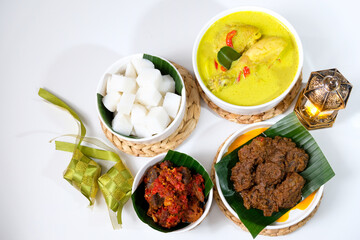 The dishes served during Eid celebrations are rendang, dendeng balado, opor ayam, and ketupat. Isolated on white background