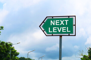 Next Level Road Sign with Dramatic Clouds and Sky.