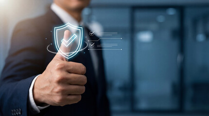 Businessman giving thumbs up with digital shield check icon for cybersecurity protection, data security and compliance approval with copy space.