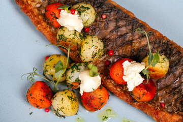 grilled fish with vegetables at a blue plate