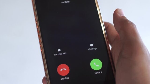 Holding smartphone displaying incoming anonymous call with question mark symbol and accept or reject options, representing mystery and potential danger