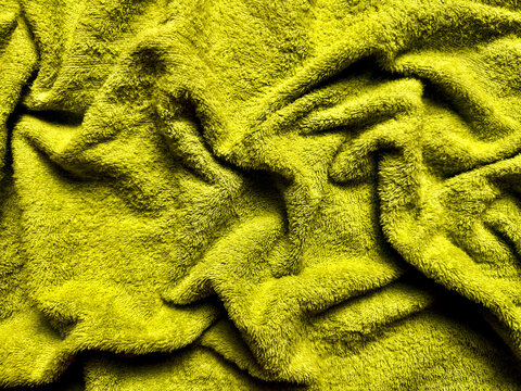 luxury chartreuse terry cloth fabric texture with deep folds and soft pile, abstract textile background for web design, print media, branding, packaging, and modern visual identity use
