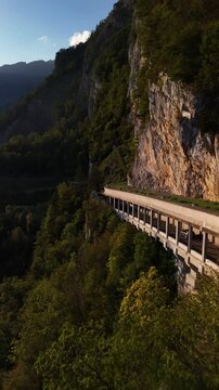 Swiss Alps mountain overpass road tunnel gallery carved into lush mountainside Switzerland