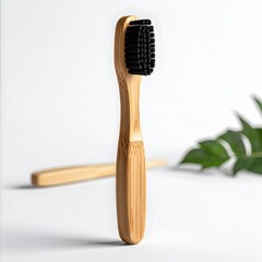 Natural Bamboo Toothbrush with Charcoal Bristles and Green Leaf Accent on White Background Eco-Friendly Dental Care