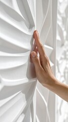 Close Up Of A Caucasian Hand Gently Touching A Textured White Wall With Natural Light
