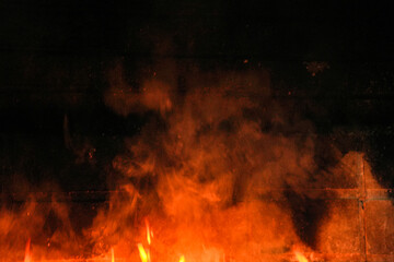 A black background with orange smoke and fire
