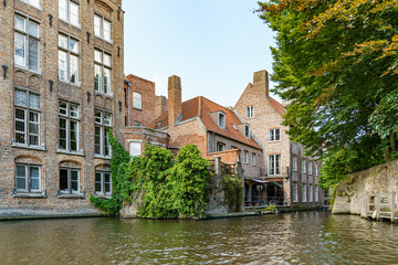 Historic red brick and partly white houses on the canal embankment in the city of Bruges, Belgium...