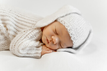 Obraz premium a newborn baby on a white isolated background, a sleeping baby, and space for text