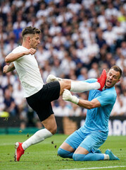 Fototapeta premium Dangerous high kick foul between football players in crowded stadium. Concept of excessive force, lack of control, emotional breakdown and critical moments in competitive football.