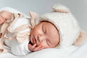 a newborn baby sleeping on a white bed at home, a newborn baby sleeping in a cocoon or swaddle, a place and space for text