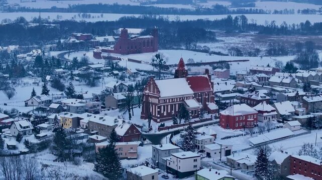 Aerial winter Teutonic Castle and church Radzyn Poland 1 4K. Brick Gothic monastery castle built 1234 AD Teutonic Knights 10th century. Historical buildings, tourist attractions, parks, farms.