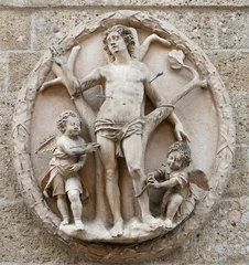 Fotobehang Jezus Christus SALZBURG, AUSTIRA - SEPTEMBER 7, 2025: The statue of St. Sebastian on the facade of Sebastiankirche by Konrad Asper (1588 – 1666).   © Renáta Sedmáková