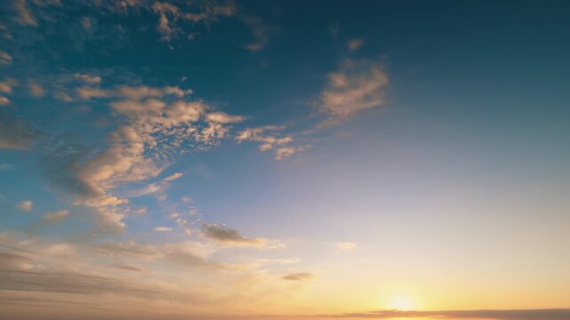 Sunset sky tranquility, Warm sunset with wispy clouds, Serene twilight glowing over cloudy horizon scenes, Pink and orange hues illuminate gentle cirrus cloud formations at sunset