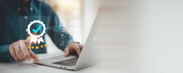 Top Quality Assurance Certification  Service Rating Concept , business person touches a virtual screen displaying a quality assurance badge checkmark certification, and business standard compliance . © A Stockphoto