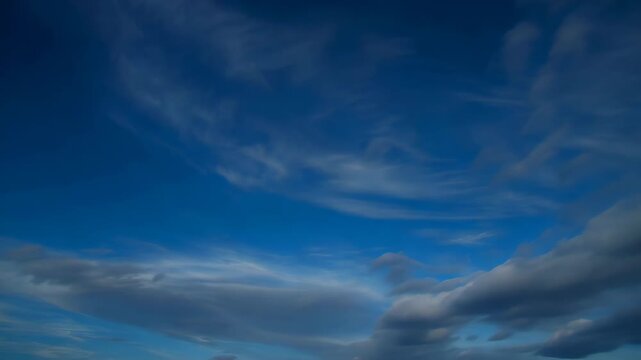 Azure Canvas: Witness the mesmerizing dance of nature as fluffy clouds meander through the vast, clear blue sky, painting a serene and tranquil scene. 