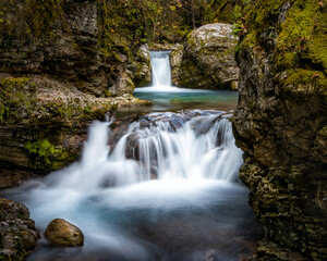 Kouiasa waterfall at Tzoumerka, Greece. A small, double waterfall, running through big stones in...