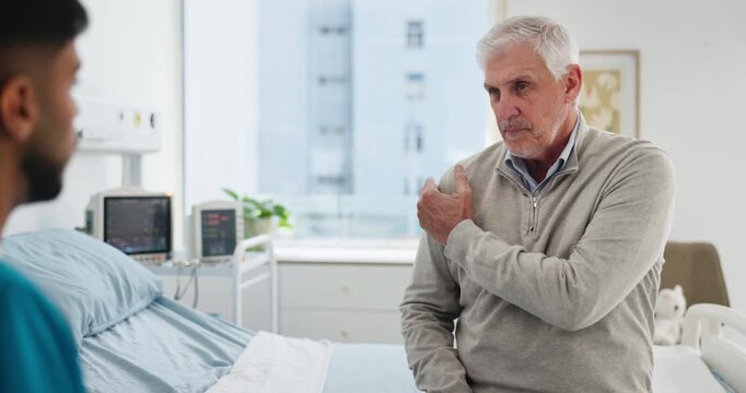 Clinic, nurse and shoulder pain with senior man for checkup, consultation and discussion for healthcare. Hospital, support and elderly patient with question for advice with injury and recovery